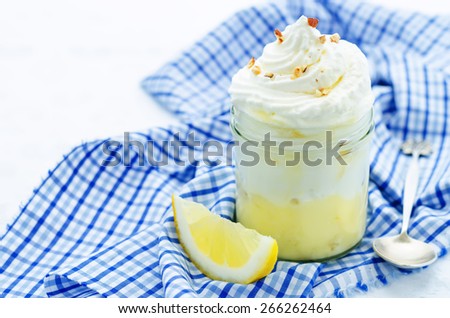 layered dessert with lemon cream, ice cream and whipped cream. tinting. selective focus
