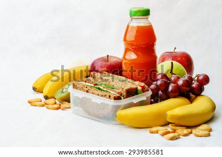 school lunch with a sandwich, fresh fruits, crackers and juice. the toning. selective focus