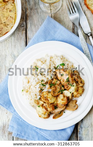 chicken baked with mushrooms and cheese with rice. the toning. selective focus