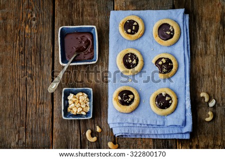 cashews butter cookies with cashews and chocolate frosting. toning. selective focus