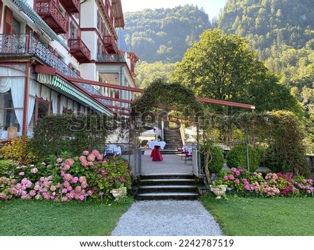 A park with a garden and green areas next to the Grand Hotel Giessbach above Lake Brienz (Brienzersee) - Kanton Bern, Switzerland (Kanton Bern, Schweiz) Stockfoto © 