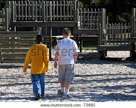 Two best friends at the playground walking towards the jungle gym to have some fun