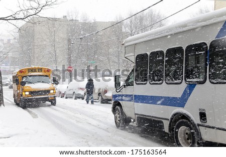 BRONX, NEW YORK - JANUARY 21: Street traffic during a 6 to 10 inch snow storm with teen temperatures along Ogden avenue and 162nd street.  Taken January  21,  2014 in the Bronx,  New York.