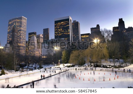 Photo of Central Park with Wollman skating rink in view and Manhattan buildings in rear.  Photographed winter, 2010, USA.