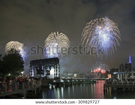 QUEENS, NEW YORK - JULY 4: Macy\'s independence day firework celebration in NYC as viewed from Gantry Plaza State Park in Long Island City.   Taken July 4, 2015 in Queens, NY.