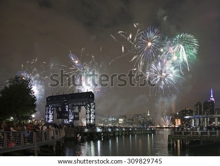 QUEENS, NEW YORK - JULY 4: Macy\'s independence day firework celebration in NYC as viewed from Gantry Plaza State Park in Long Island City.   Taken July 4, 2015 in Queens, NY.