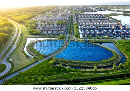 Modern sustainable neighbourhood in Almere, The Netherlands. The city heating (stadswarmte) in the district is partially powered by a solar panel island (Zoneiland). Aerial view.
