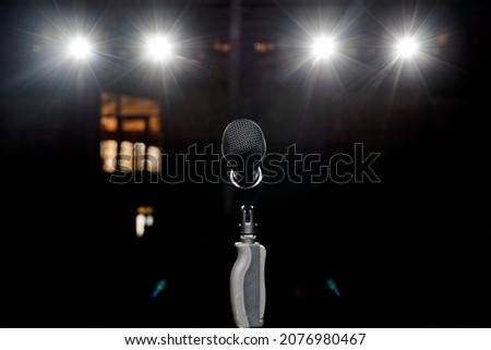 Microphone on the stand with hand nozzle in the center tage with beautiful bokeh spotlights in the background. High quality photo Photo stock © 