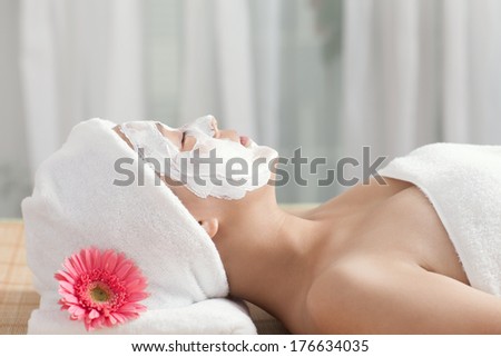 A young woman enjoying spa mask