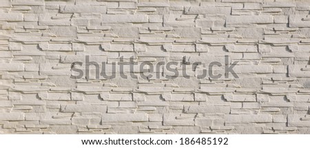 White cladding tiles imitating stones in sunny day