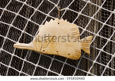 Two fishing nets and wooden fish for decoration