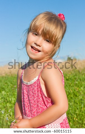 Funny girl in a pink dress with flowers