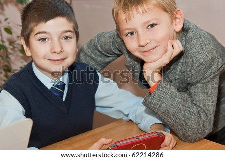 Elementary school. Schoolboys with  electronic game in the school