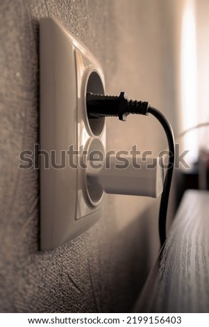 Socket with connected devices. Electric socket in the wall with connected appliances Сток-фото © 