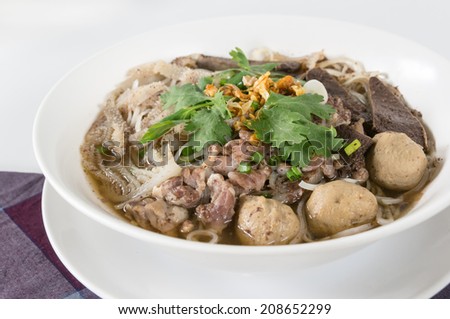 Combination Beef Noodle with beef ball, beef tripe, beef liver, BBQ Duck, Bean Sprouts, Green Lettuces, Green Onions, Cilantro, spicy sour minced jalapeno and Dried Garlic