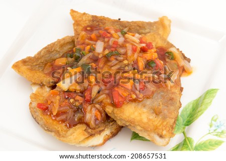 Fish Fillet with three flavor spicy sauce contains garlic, chili sauce, mushrooms, white onions, bell pepper, basil leafs