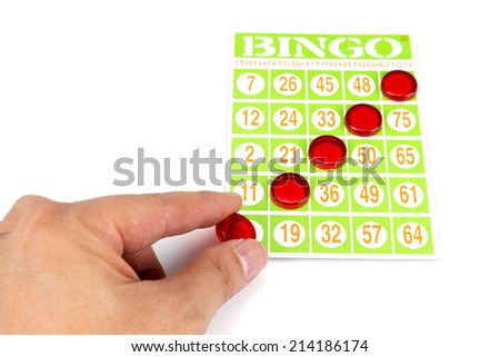 hand putting last chip to be winner of bingo game isolated on white background