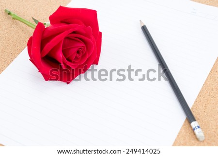 Cardboard, cork board with note paper with pencil and rose beside for romantic planning, space for text