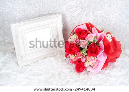 flowers bouquet placed with picture frame which have white space for your image
