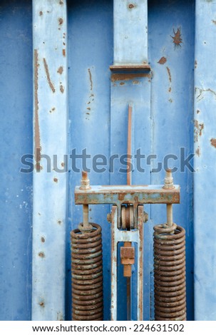 Detail of old blue rusty metal container.