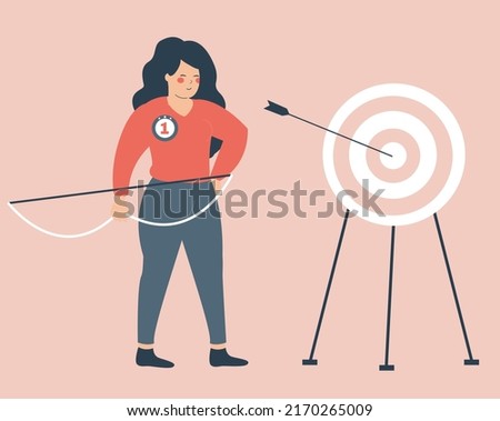 Strong girl shooting a bow and hits the target. Businesswoman achieve her goals in career and life. Woman hits the bull's eye of the dartboard. Concept of Archery, business victory and empowerment. 