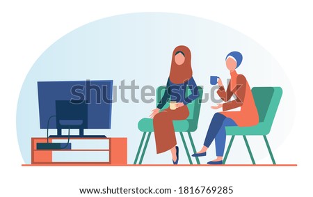 Muslim women sitting and watching TV. Tea, hijab, home flat vector illustration. Leisure and entertainment concept for banner, website design or landing web page