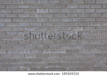 wall from gray concrete bricks under the influence of precipitation