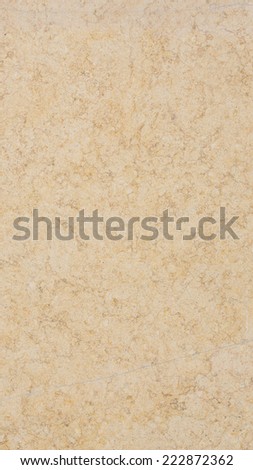 large slab of mottled beige and yellow marble with a flat smooth polished surface