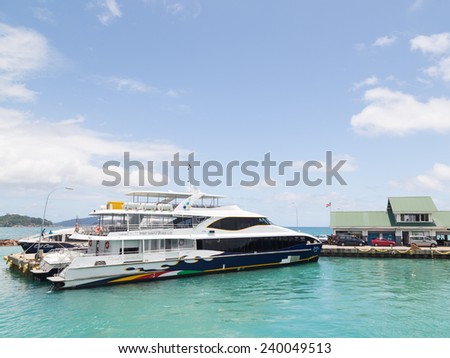 Praslin - November 3, 2014: Ferry on the dock at the port, develops Seychelles flag and turquoise sea water 3 November 2014, Praslin, Seychelles