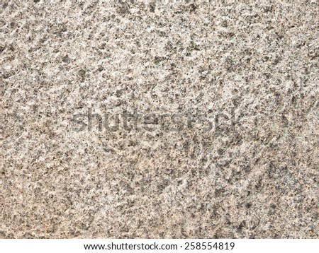 wall of a very old brown rough solid porous natural stone