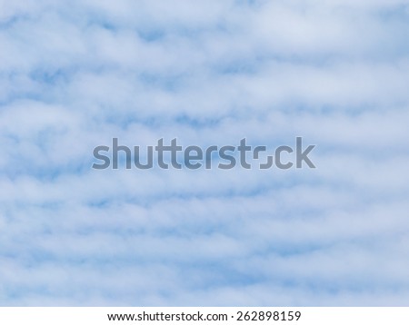 beautiful white cumulus clouds unusually settled stripes against a bright blue sky