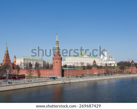 Moscow - April 12, 2015: Kremlin Embankment, people walking and cars go along the Kremlin walls and clearly visible architectural ensemble of the  Kremlin April 12, 2015, Moscow, Russia