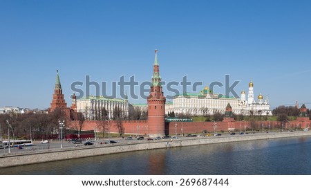 Moscow - April 12, 2015: View of the Kremlin Embankment, people walking and cars go along the Kremlin walls and clearly visible architectural ensemble of the Kremlin April 12, 2015, Moscow, Russia