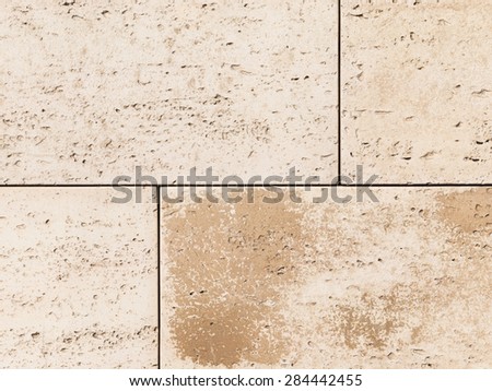 beautiful light beige natural travertine with dark brown spots and depressions in the bars