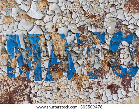 old rusty painted metal surface with peeling paint chipping