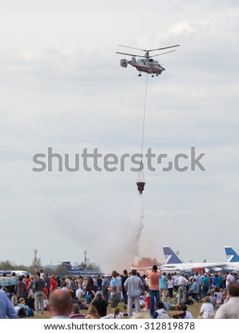 The Moscow region - August 28 2015: Multi-purpose helicopter Ka-42 releases water in the demonstrations at the air show Max and people photographed in 2015 August 28, 2015, Moscow, Russia