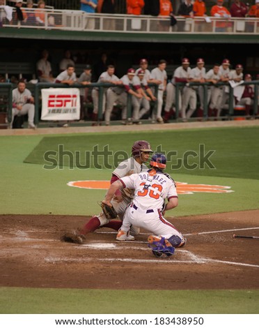 Clemson, SC, USA - March 21, 2014: Clemson catcher #30 Garrett Boulware tags out Florida State base runner Jose Brizuela