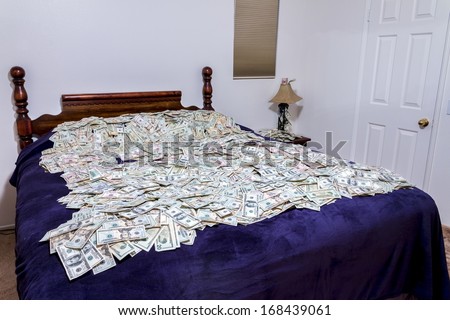 A bed covered in money