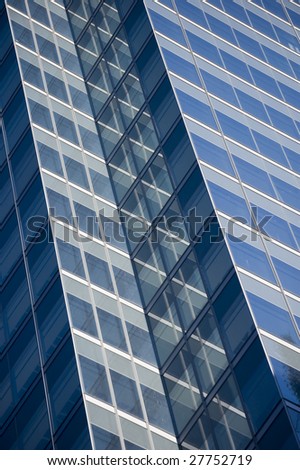 close up of reflective glass surface on skyscraper / abstract building background