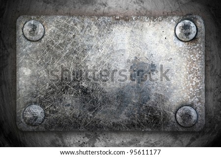 metal tag on clips (rivets) ; scraped texture ; abstract grunge background