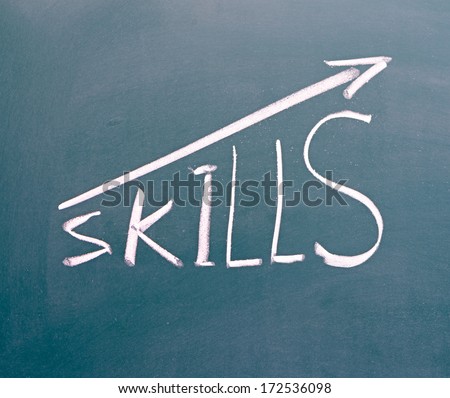 word Skills hand written on the chalkboard with rising arrow graph