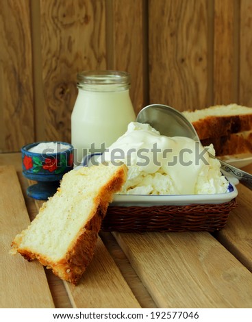 Cottage cheese, sour cream and fresh bread for breakfast