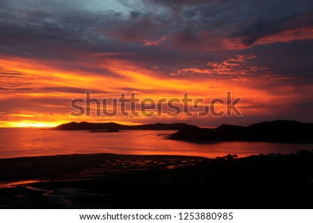 Similar – Image, Stock Photo Sunset on Thursday Island. In the golden glow, the water shines. In front a group of trees and behind a small island with passage to the sea.