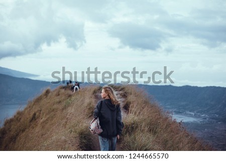 Woman posing in the volcano with backpack.street photo portrait, l girl,using backpack, travel vibes, hipster girl, outdoor close up portrait, happy face, Bali, hipster mood, crazy atmospher Stock fotó © 