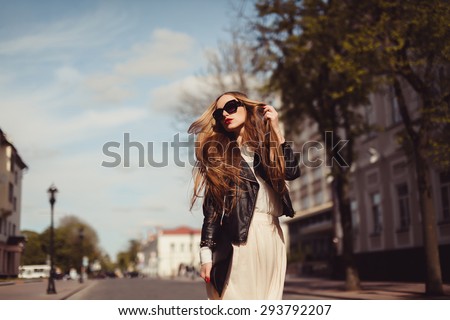 beautiful blonde girl in sunglasses posing with red lips on the street the wind in your hair sun street fashion clothing