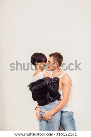 Romantic young hipster couple holding hands,falls in love together,bright casual street outfit, family, relax, lovers, bright sneakers, close up couple faces.man flirting with her girlfriend