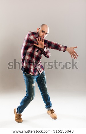 the bald guy posing in the Studio in a plaid shirt