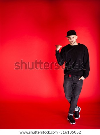 the guy in the denim jacket baseball cap posing in studio