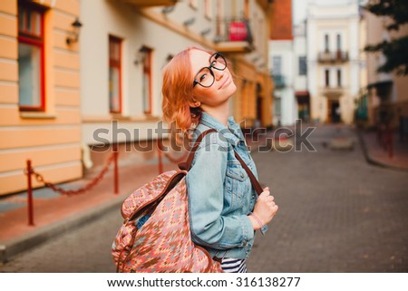 City fashion portrait of young business woman,teen student girl,wearing elegant sky blue suit, curly amazing hairs, vintage sunglasses, soft warm colors. Happy mood.student collage