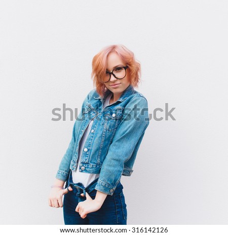 Outdoor fashion portrait of young teen hipster girl, street style swag look, hat, mom jeans, neon colors, travel at Europe.Cool autumn denim outfit,Shy teen girl,fancy girl,cozy style